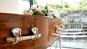 A picture of a coffin on the article how wrongful death proceeds are divided