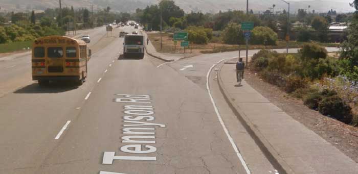 Two bicyclists approach a faded crosswalk lacking MUTCD signage at the eastbound-northbound onramp. (Source: Google Streetview)