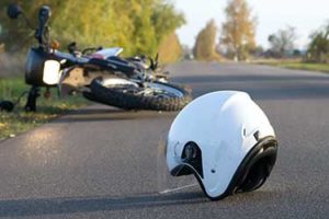 Motorcycle Accident on a road with a helemet