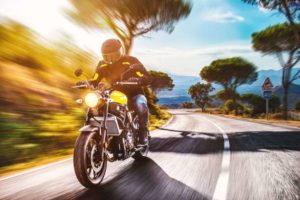 A motorcycle rider driving down a San Francisco Road