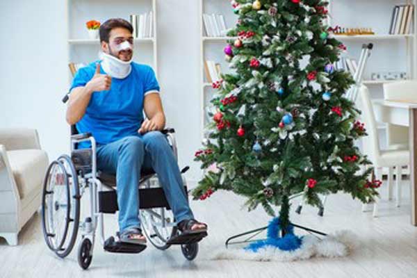 Holiday Injury Example. Man injured in front of Christmas tree