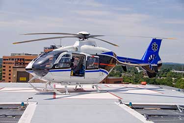 A flight for life helicopter sitting on a hospital landing pad