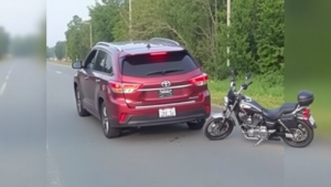 a car parked next to a motorcycle