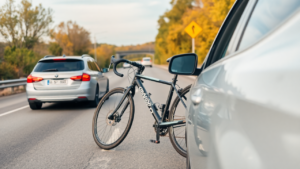 a bicycle parked on the side of a car