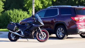 a motorcycle parked in front of a car