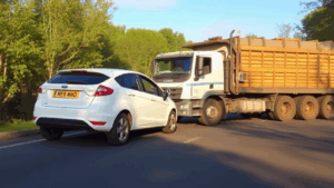 a car and semi-truck collision on the road