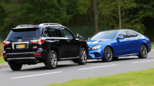 a black car and blue car on a road