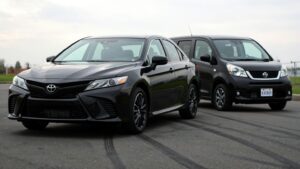 Two black cars parked side by side