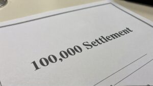 Document stating settlement amount of $100,000