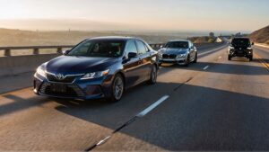 Three cars driving on a highway.