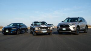 Three cars parked on a road.