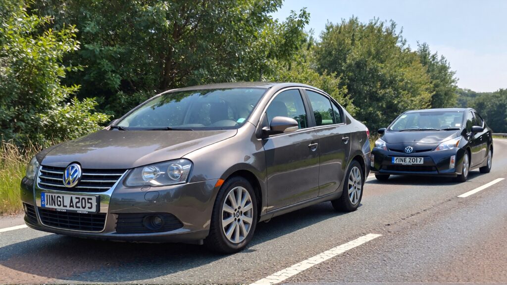 Juris digital a gray Volkswagen Jetta and a Toyota Prius on the road b3fc3336 1e4d 4b6e b4e4 9c2f018b3af8