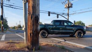 Pickup truck passing intersection with pole