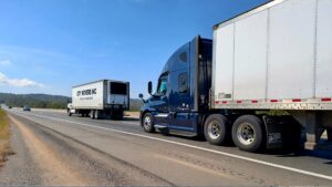 Two trucks driving on highway