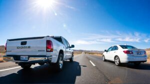 Two cars driving on an open road