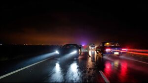 Cars driving on a wet, dark road