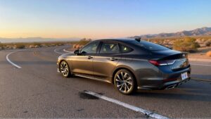 Hyundai sedan on desert road at sunset