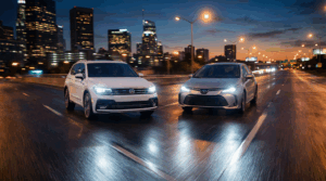 Two cars driving in city at night