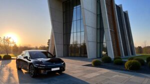 Black car near modern architectural building.