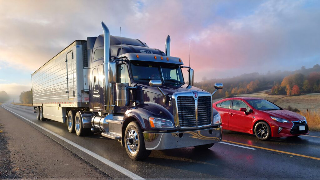 Samantha parian a semi truck and a red Toyota Prius in the morning 946d4532 e53d 41aa 83fc f88c87f74033