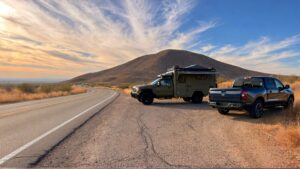 Two vehicles parked by scenic road.