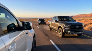 Three vehicles driving on highway