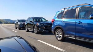 Three cars on a highway.