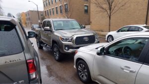 Grey SUV and silver Tacoma parked