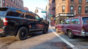 Black SUV and old station wagon