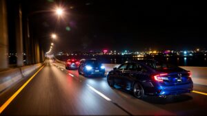 Cars driving on a lit highway