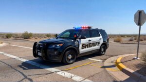 Sheriff's car at intersection, sunny day