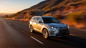 Silver Toyota Highlander driving on highway