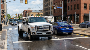 White truck and blue sedan intersection