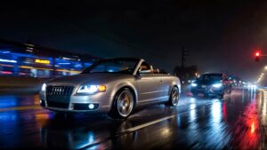 Two cars driving in rainy night