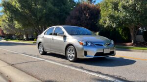 Silver Toyota sedan driving on road