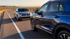 Two Volkswagen cars on a road