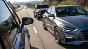 Two cars driving on a highway.