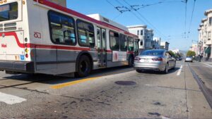 Muni bus and car on street