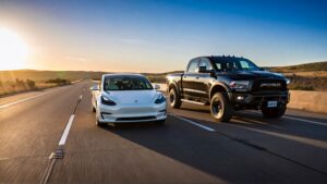 Tesla and Dodge truck on highway