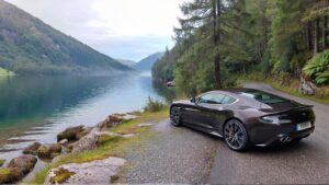 Luxury car by serene lake