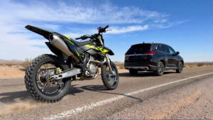 Dirt bike and SUV on road.