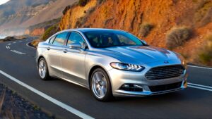 Silver Ford driving on coastal road