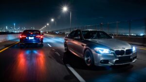Two cars racing on a highway.