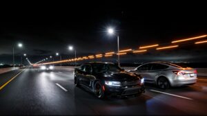 Two cars racing on a highway