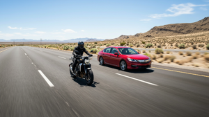 Motorcycle and car on highway