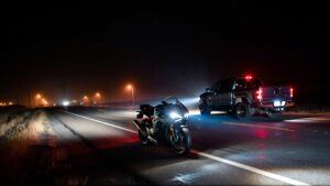 Motorcycle and truck on dark highway