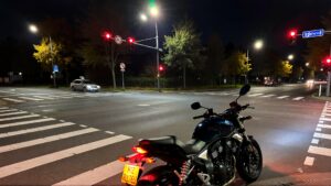 Motorcycle parked at a traffic light.