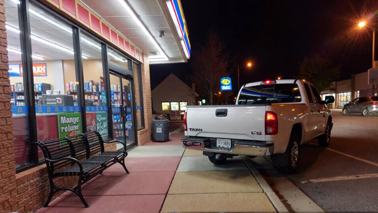 Juris digital a pick up truck on the sidewalk outside a convenience store at ni 9c88f798 2a09 47d4 9045 f778c482aa39