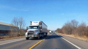 Truck driving on a clear highway.