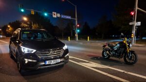 Hyundai SUV and motorcycle at intersection